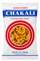 A 7 oz bag of Vijaya Foods Chakali, featuring a white bag with a blue and red logo banner and a circular window showing the golden-brown crispy snack inside.